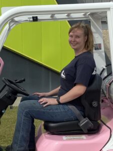 Victoria Parrish on a pink Toyota forklift. 