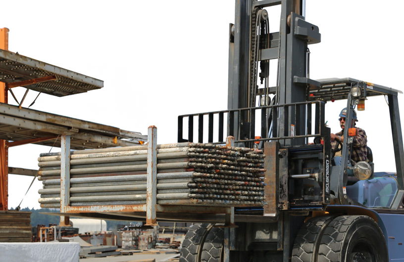 Parking lot with many forklifts lined up in rows.