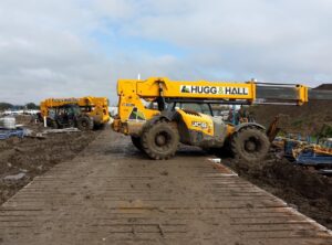 Hugg & Hall rental equipment telehandler working safely in muddy conditions.