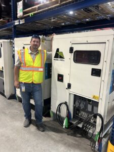 Jerrod English stands in front of utility services equipment.