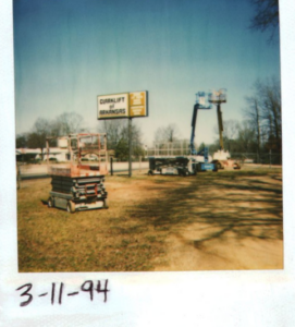 polaroid photo of the Clarklift of Arkansas equipment yard and dealership sign from 1994