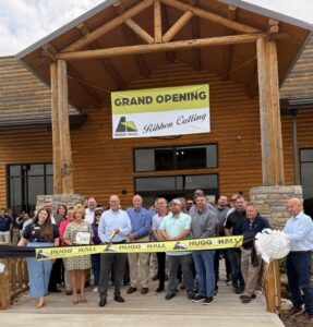 Group of people for a ribbon cutting for the grand opening of the Glenpool location
